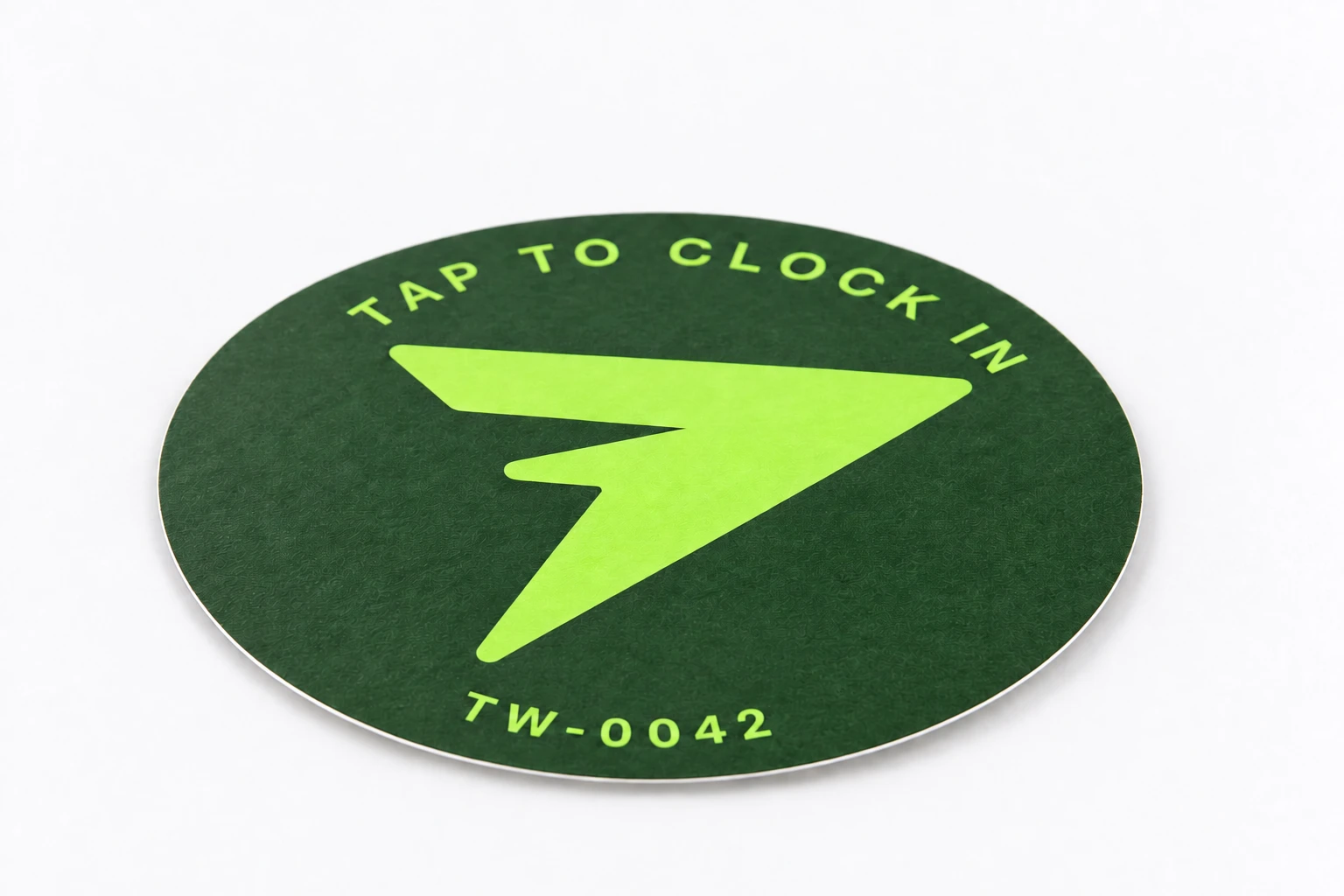 Studio illustration of the thin circular TapWren Tag on a pale surface