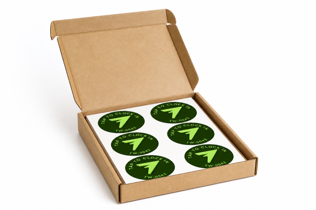 An open mailer box holding a liner sheet of six TapWren Tags.