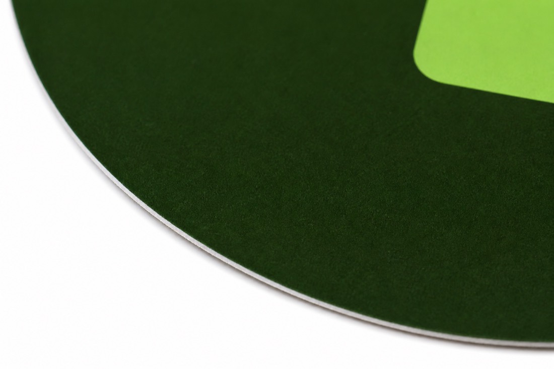 Macro view of the die-cut rim, showing the white paper core beneath the matte print.