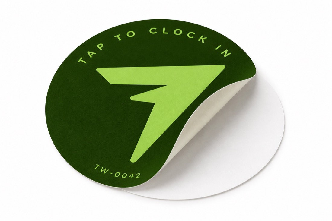 A TapWren Tag lifted off its liner, showing the plain adhesive underside.